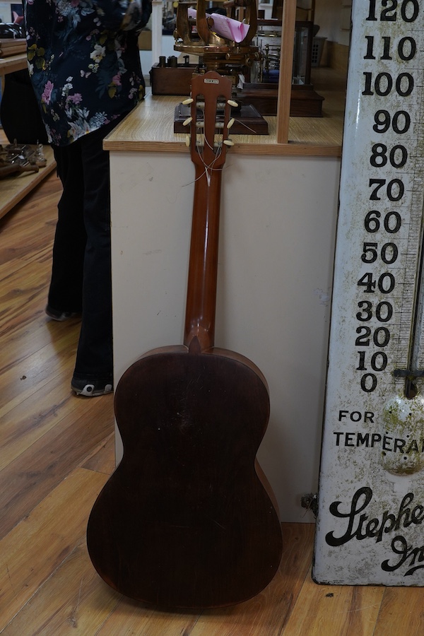 A Suzuki classical guitar, no.3067. Condition - fair, one string missing and scratches to the body.